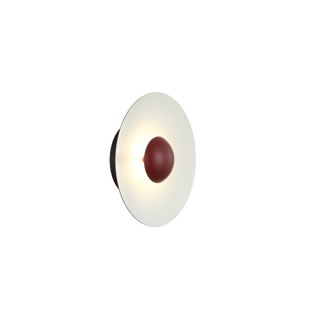 Round wall light fixture with a white shade and red center